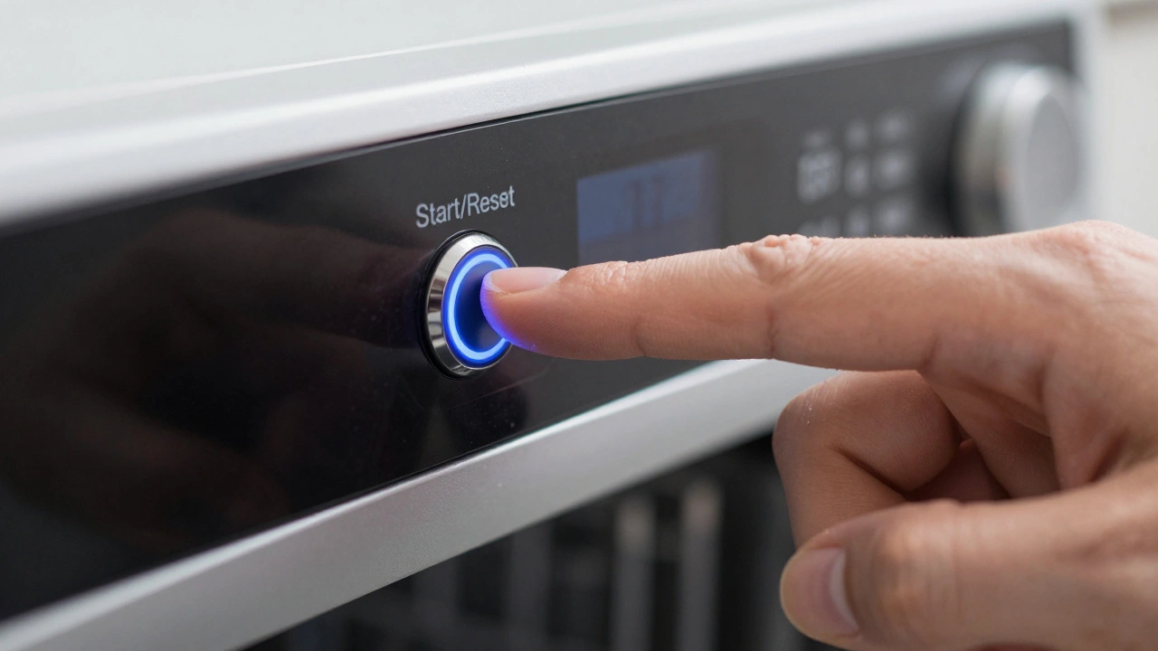 Hand pressing reset button on dishwasher control panel close-up